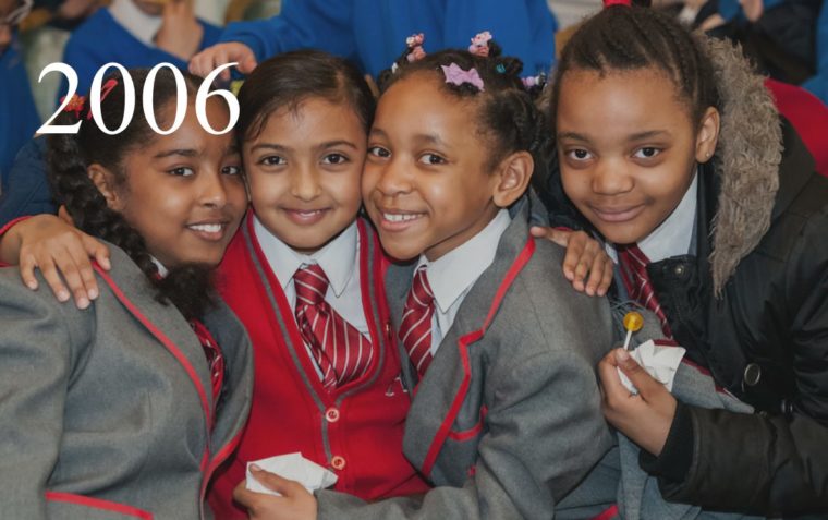 Four primary school girls sitting closed together.