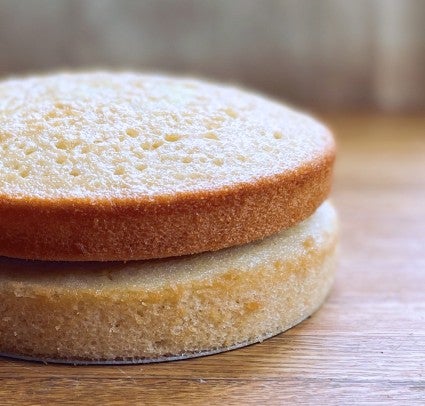 Two cake layers stacked, one golden brown, one a darker golden brown.