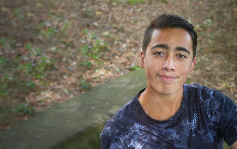 Photo of teenager Ahmad Nawaz in a blue t-shirt smiling