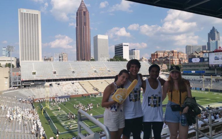 4 group of friends attending an American football game