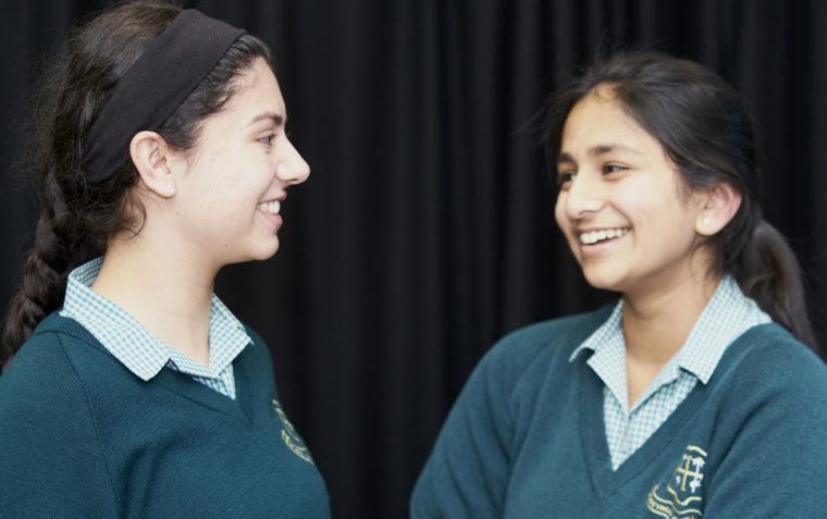 Two students joyfully conversing with one another