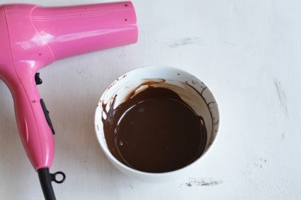 Melted chocolate in bowl next to hair dryer