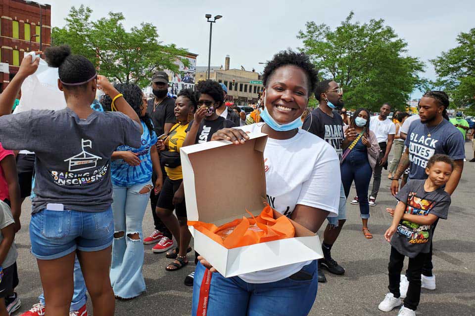 Woman holding sweet potato pie at protest