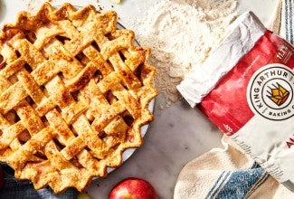 King Arthur all-purpose flour bag next to baked pie