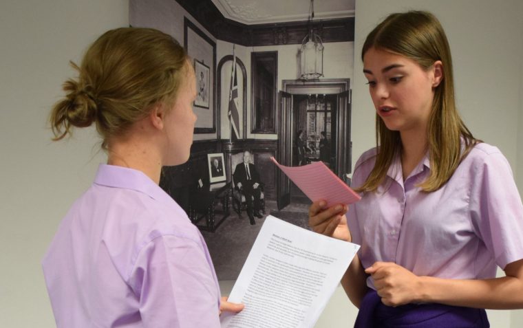 Two students reciting their speeches with one another