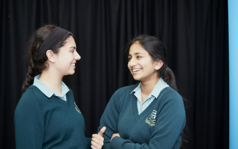 Two students joyfully conversing with one another