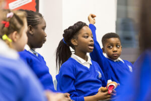 A small group of students speaking and listening to each other in a classroom
