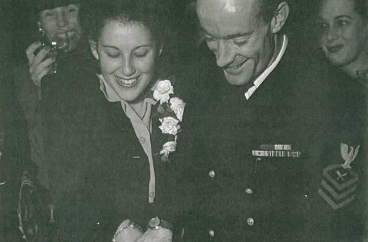 Black and white picture of couple cutting a wedding cake