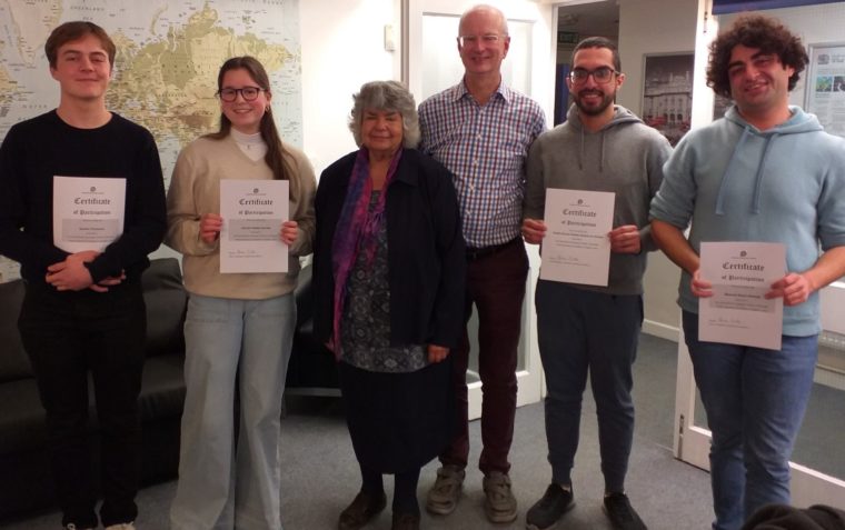 People posing with their certificates
