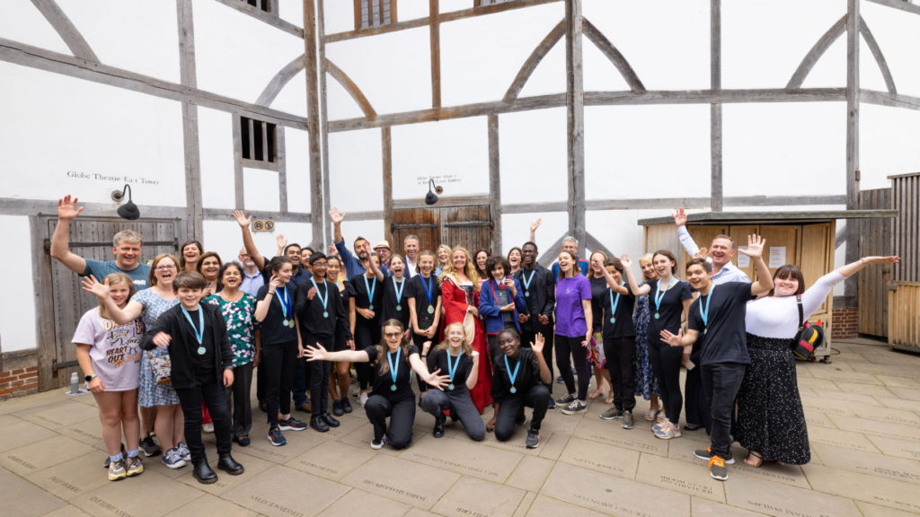 An inclusive group picture that comprises of primary school pupils, secondary school students, tutors and event organisers. 