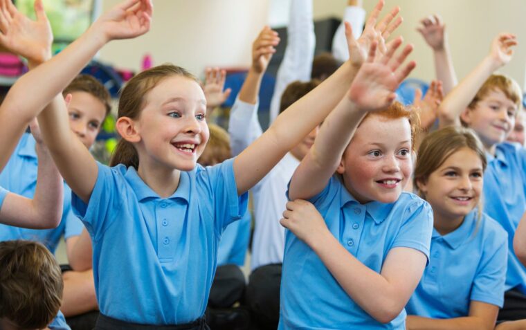 Pupils raising their hands during an oracy in action workshop