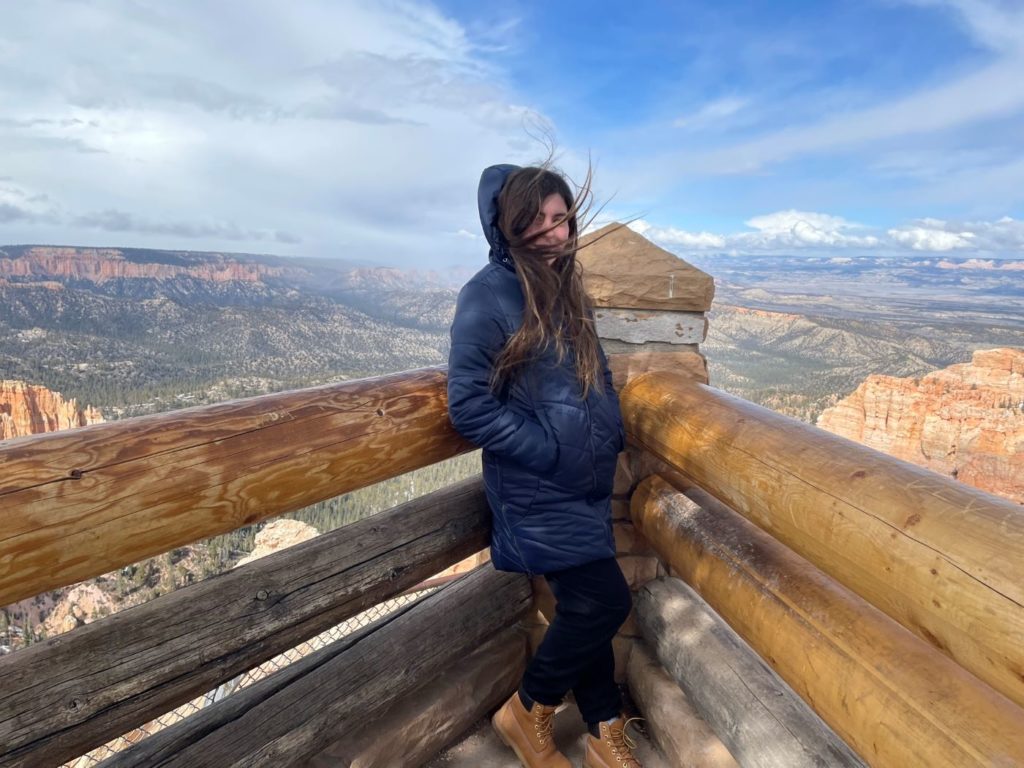 windswept girl on a hill