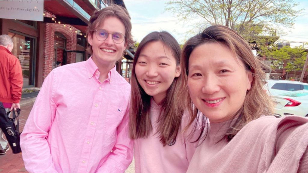 three people smiling at the camera